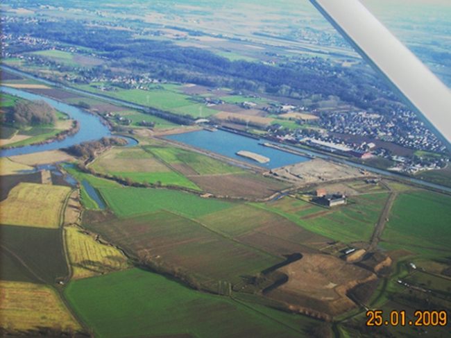 Het verwerkingsbekken gezien vanuit de lucht met op de voorgrond het gronddepot. Aan de linkerkant in het midden van de foto ziet u de bocht van de Maas bij Voulwammes.