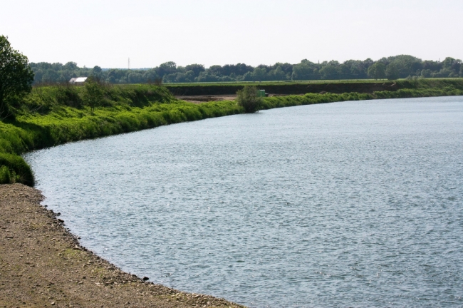 Vanaf Voulwammes kun je de vorderingen aan de stroomgeulverbreding ook  zien. Op dit punt nabij de uitmonding van de Geul in de Maas is de dekgrond al afgegraven. Dit is het gebied waar een bouwkeet achter een struik nog net zichtbaar is aan de rand van de Maas. 