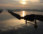 De ondergaande zon spiegelt in het ijs dat zich op de laatste dag van 2008 alsnog heeft gevormd op het water in het verwerkingsbekken. Over een week zal men starten met het verwijderen van de damwand in het Julianakanaal. (31-12-2008 - Jan Dolmans)