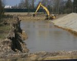 Op de achtergrond de woningen van Op de Hoogmaas met daarvoor de geluidswal van zeecontainers. Na enkele meters zit men al op het nivo van het grondwater. (1-4-2009 - Jan Dolmans)