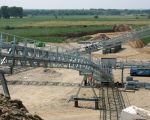 Aan de westzijde van de grint-terp wordt een identieke transportinstallatie gebouwd om een voorselectie te maken op het aangevoerde grint. (25-6-2009 - Jan Dolmans)